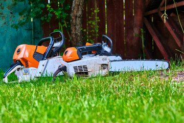 two professional gasoline saws on the grass. general plan