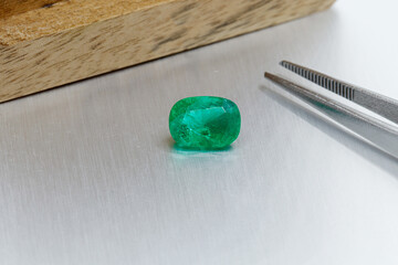macro mineral faceted stone Emeralds on a gray background