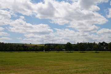 Fototapeta premium a field with windmills in Germany on a Sunny summer day
