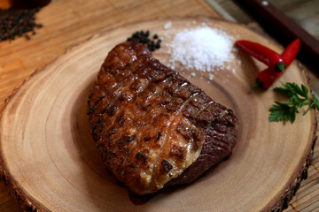 Picanha. Traditional Brazilian barbecue with steak in background. 