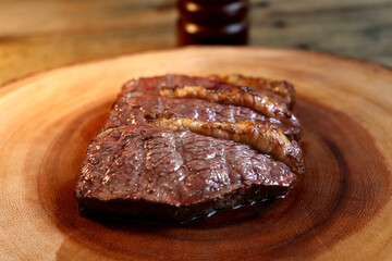 Picanha. Traditional Brazilian barbecue with steak in background. 