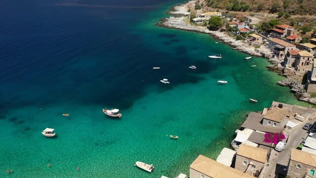 Aerial drone video of beautiful small seaside village of Limeni with emerald clear sea, Mani Peninsula, Lakonia, Peloponnese, Greece