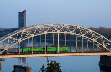 Electric train passing the bridge over Daugava in Riga