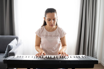 Woman Playing Music Keyboard Piano © Andrey Popov