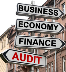 Obraz premium The road indicator on the arrows of which is written - business, economics, finance and AUDIT