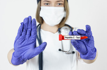 The doctor holds in his hands a test tube with blood tests for the virus - Hepatitis C with the...