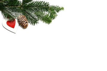 Christmas background with fir branch, pinecones and ornaments on white background.