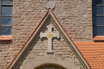 stone cross on a stone wall in Germany on a Sunny summer day