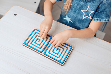 Top view of a children's educational puzzle in the form of a labyrinth. Child development. Childhood. Brain concept. photo with noise