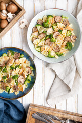 Mushroom pasta salad with steamed broccoli and baked chicken meat slices