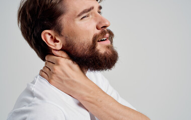 Obraz premium young man touching neck with hands spine pain side view model portrait