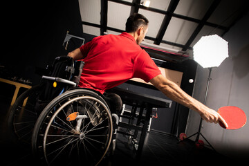 Fototapeta na wymiar Wheelchair user playing table tennis