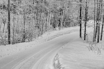 Snow covered scene with a cleared clean road landscape