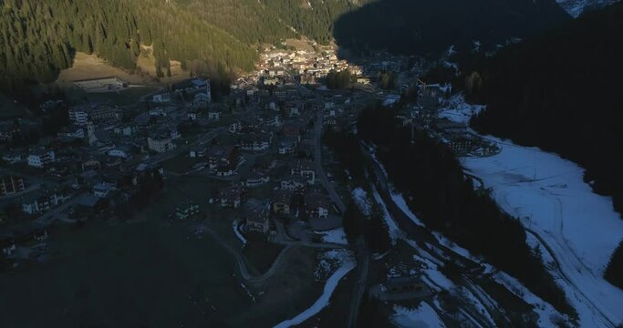 Aerial above village at winder with mountains peak snow view. Drone fly over alpine dolomites snowy Italy Pieve di Cadore