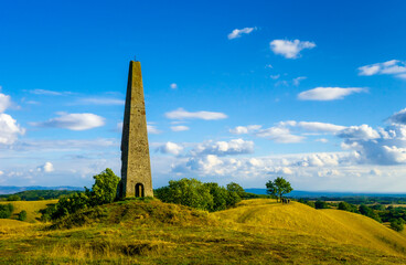 landscape with sky and clouds and old stone tower