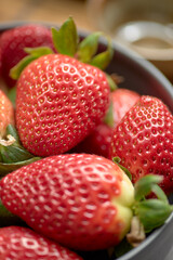 Close-up of fresh strawberries in a gray bowl