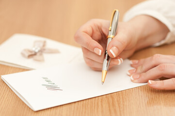 Woman writing on a wedding menu