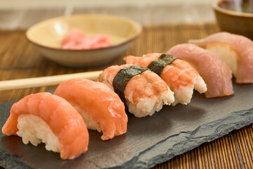 Closeup shot of salmon nigiris on a board