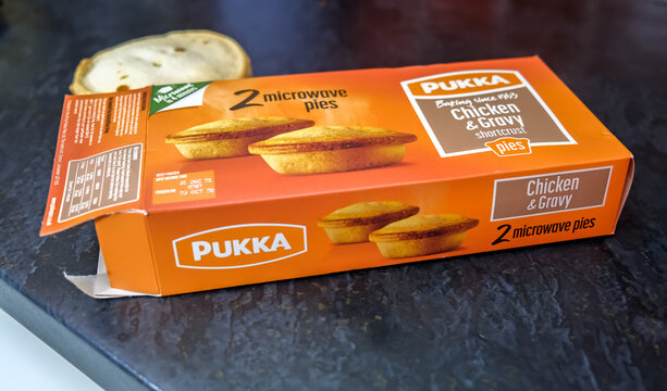 Norwich, Norfolk, UK &ndash; December 05 2020. An illustrative photo of a box of Pukka branded frozen readymade shortcrust pastry chicken and gravy microwavable pies on a kitchen work surface