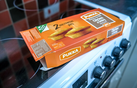 Norwich, Norfolk, UK &ndash; December 05 2020. An illustrative photo of a box of Pukka branded frozen readymade shortcrust pastry chicken and gravy pies on a cooker