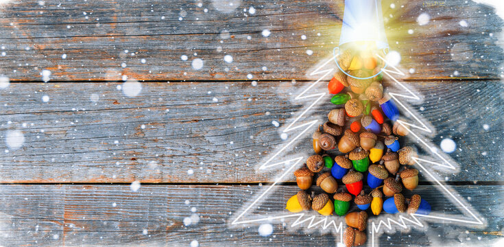 Merry Christmas and happy New Year card celebration old craft styling Christmas tree made of colored acorns.
