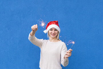 Obraz premium Beautiful girl on a blue background, New Year