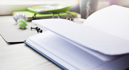 Open notebook on the table. Business planning, business planning. Office equipment in the workplace. Conceptual image of office work.