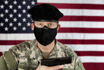 Armed military man wearing mask for protection against the coronavirus while serving his country