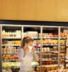 supermarket shopping, face mask,Woman choosing a dairy products at supermarket.