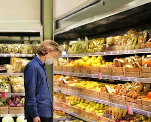 Supermarket shopping, face mask and gloves,man buying fruits at the market.