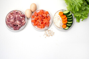 Pet dog food from natural ingredients. Raw meat, fish, vegetables, eggs and salad. concept of a correct balanced and healthy nutrition for pet,