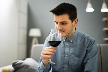 Man Drinking Red Wine In Video Conference