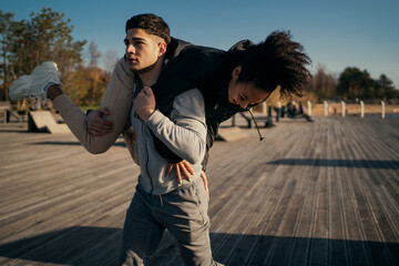 A man and an African-American woman in sports comfortable clothing for aerobics fitness training on...