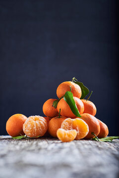 mandarins freshly picked from the tree on a rustic wooden surface