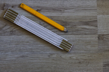 folding rule and yellow pencil