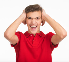 Photo of  young  screaming man looking at camera isolated on white background. Portrait of handsome guy touching his head with a expressive emotions .  Funny portrait of Teenager .