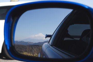Fototapeta na wymiar Mt. Fuji in the reflection of a GTR Rearview mirror