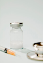 vaccine in glass vial, with white plane, blue background