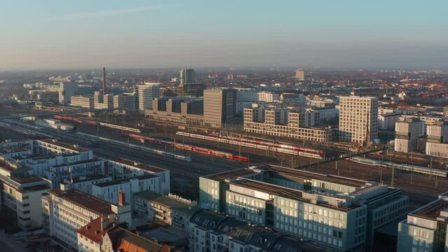 Forward Flight over Munich, Germany Central Train Station Train Tracks on beautiful Sunny Day with little Traffic due to Coronavirus Covid 19 Pandemic 