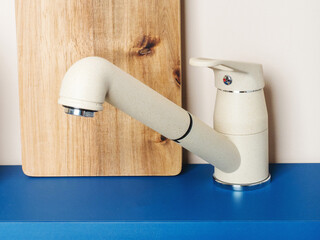 Fototapeta premium Water tap and sink in a modern kitchen. Faucet in the kitchen is isolated. Luxury faucet. Modern kitchen.