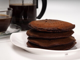 Close up shoot of stacked brown chocolate flafor pancake on an isolated white background