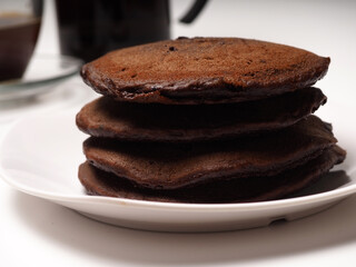 Close up shoot of stacked brown chocolate flafor pancake on an isolated white background