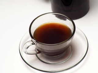 A cup of coffee and french press on a white isolated background