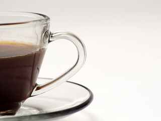 A cup of coffee and french press on a white isolated background