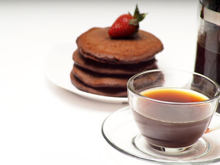 Close up shoot of stacked brown chocolate flafor pancake on an isolated white background