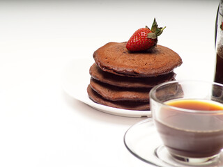 Close up shoot of stacked brown chocolate flafor pancake on an isolated white background