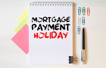 Mortgage Payment Holiday write on crunched paper isolated on wooden table