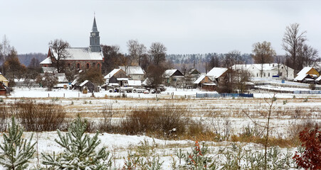 Panoramic view of beautiful white winter rural landscapes on cold sunny day with gray blue sky