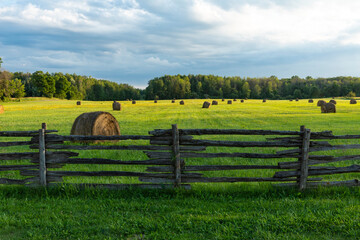 fence, hay bales and fields