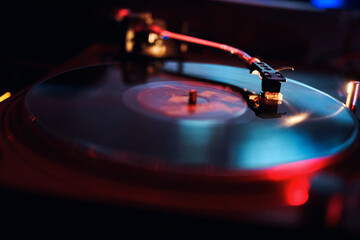 dj vinyl record in a nightclub with beautiful colors and reflections
